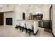 Cozy seating at the bar with fireplace and view to the living and dining area at 9325 Canyon Classic Dr, Las Vegas, NV 89144