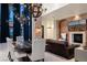 Elegant living room featuring high ceilings, a stone accent wall, and designer light fixtures at 9325 Canyon Classic Dr, Las Vegas, NV 89144