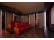 A theater room with tiered seating, red leather chairs, a projector, and a popcorn machine for entertainment at 9325 Canyon Classic Dr, Las Vegas, NV 89144