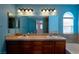 A large bathroom with tile countertops, a double vanity, tile floors and a bathtub at 9449 Amber Valley Ln, Las Vegas, NV 89134