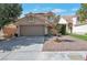 Charming home featuring a spacious two-car garage, well-kept landscaping, and a welcoming front entrance at 9449 Amber Valley Ln, Las Vegas, NV 89134