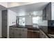 Open-concept kitchen with stainless steel appliances, granite countertops, and access to backyard at 9449 Amber Valley Ln, Las Vegas, NV 89134