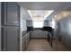 Stylish kitchen with grey cabinets, stainless steel appliances, and plenty of natural light from a skylight at 9449 Amber Valley Ln, Las Vegas, NV 89134