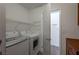 Functional laundry room equipped with modern appliances and practical storage shelves at 9449 Amber Valley Ln, Las Vegas, NV 89134