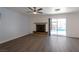 Spacious living room with fireplace, wood flooring and access to the backyard at 9449 Amber Valley Ln, Las Vegas, NV 89134