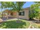 Backyard featuring a covered patio, lush green turf and decorative landscaping at 950 Marbelwood Ave, Las Vegas, NV 89123