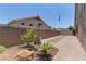 Outdoor area with paver patio, mature plants, decorative rocks, and privacy wall at 950 Marbelwood Ave, Las Vegas, NV 89123