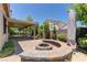 Outdoor space with covered patio and built-in seating area around a cozy firepit at 950 Marbelwood Ave, Las Vegas, NV 89123