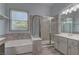 This bathroom includes a walk-in shower and a garden tub at 950 Marbelwood Ave, Las Vegas, NV 89123