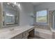 This light and bright bathroom features a garden tub and a large vanity at 950 Marbelwood Ave, Las Vegas, NV 89123