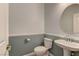 Neat powder room featuring wainscotting, pedestal sink, and an oval mirror at 950 Marbelwood Ave, Las Vegas, NV 89123