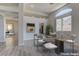 Elegant dining area featuring modern decor, a glass top table, with easy access to the living room and kitchen at 950 Marbelwood Ave, Las Vegas, NV 89123
