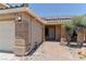 Front exterior of a house featuring desert landscaping, pavers and a three car garage at 950 Marbelwood Ave, Las Vegas, NV 89123