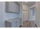 This hallway features built-in storage cabinets and wood-look flooring at 950 Marbelwood Ave, Las Vegas, NV 89123