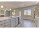 Open-concept kitchen boasts stainless steel appliances, a spacious island, sleek countertops and backyard views at 950 Marbelwood Ave, Las Vegas, NV 89123