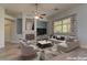 Cozy living room showcasing a fireplace, modern sectional, stylish chairs, and natural light from the backyard at 950 Marbelwood Ave, Las Vegas, NV 89123