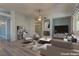 Relaxing living room featuring a cozy fireplace, comfortable seating, modern décor and abundant natural light at 950 Marbelwood Ave, Las Vegas, NV 89123
