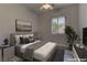 The virtually staged main bedroom features a ceiling fan and large window at 950 Marbelwood Ave, Las Vegas, NV 89123