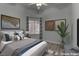 This is a virtually staged main bedroom with gray and blue tones and modern fixtures at 950 Marbelwood Ave, Las Vegas, NV 89123