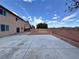 Expansive backyard with concrete patio, low-maintenance yard, brick perimeter walls, and desert landscaping at 9604 Vital Crest St, Las Vegas, NV 89123