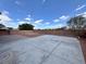 Large backyard with concrete patio, desert landscaping and brick walls at 9604 Vital Crest St, Las Vegas, NV 89123