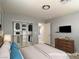 Staged bedroom with closet, TV, and dresser with decor at 9604 Vital Crest St, Las Vegas, NV 89123