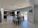 Open dining area with a stylish chandelier, sliding door to the back yard, and stainless appliances at 9604 Vital Crest St, Las Vegas, NV 89123