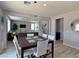 Open dining area showing access to the living room with recessed lights and a dining table for six at 9604 Vital Crest St, Las Vegas, NV 89123