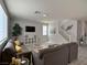 Spacious living room featuring modern decor, neutral paint, laminate flooring, and large staircase at 9604 Vital Crest St, Las Vegas, NV 89123