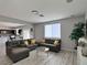 Open concept living room features modern furnishings and seamless flow to the kitchen at 9604 Vital Crest St, Las Vegas, NV 89123
