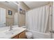 The bathroom features a single sink, a bathtub with a white shower curtain, and charming dolphin-themed artwork at 967 Coronado Peak Ave, Las Vegas, NV 89183