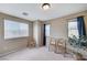 Bright bedroom with three windows and neutral carpet featuring three chairs and a potted plant at 967 Coronado Peak Ave, Las Vegas, NV 89183