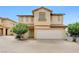 Inviting two-story home with a two car garage and lush landscaping in the front yard at 967 Coronado Peak Ave, Las Vegas, NV 89183