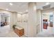 A hallway with neutral walls and carpet flooring featuring a decorative bench between two door frames at 967 Coronado Peak Ave, Las Vegas, NV 89183