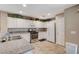Well-lit kitchen featuring tile floors, white cabinetry, and stainless steel appliances at 967 Coronado Peak Ave, Las Vegas, NV 89183