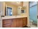Bathroom with a large vanity, mirror, and toilet and bath/shower with a curtain at 9746 Vista Cache Ct, Las Vegas, NV 89148