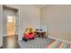 Bedroom features wood floors, a play area, and neutral wall colors at 9746 Vista Cache Ct, Las Vegas, NV 89148
