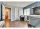 Bedroom with ensuite bathroom, closet, hardwood floors and blue accent wall at 9746 Vista Cache Ct, Las Vegas, NV 89148