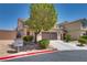Charming two-story home with desert landscaping, driveway, and two car garage at 9746 Vista Cache Ct, Las Vegas, NV 89148