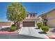 Charming two-story home with desert landscaping, driveway, and two car garage at 9746 Vista Cache Ct, Las Vegas, NV 89148