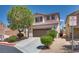 Charming two-story home with desert landscaping, driveway, and two car garage at 9746 Vista Cache Ct, Las Vegas, NV 89148