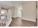 Upstairs hallway with hardwood floors and access to various rooms at 9746 Vista Cache Ct, Las Vegas, NV 89148