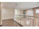 Upstairs hallway features hardwood floors, white railings, and bedrooms at 9746 Vista Cache Ct, Las Vegas, NV 89148