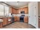 Bright kitchen features stainless appliances, wood cabinets, and a sink with natural light at 9746 Vista Cache Ct, Las Vegas, NV 89148