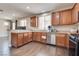 Modern kitchen with stainless steel appliances, light countertops, and dark wood-look flooring at 9746 Vista Cache Ct, Las Vegas, NV 89148