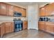 Functional kitchen featuring stainless steel oven, wood cabinets, and plenty of counter space for cooking at 9746 Vista Cache Ct, Las Vegas, NV 89148