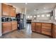 Open kitchen with stainless steel refrigerator, ample counter space, and a seamless view into the living area at 9746 Vista Cache Ct, Las Vegas, NV 89148