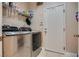 Laundry room with stainless steel washer and dryer, storage shelves, and door to outside at 9746 Vista Cache Ct, Las Vegas, NV 89148