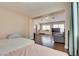 Open living room area with hardwood floors, large windows, and an armchair at 9746 Vista Cache Ct, Las Vegas, NV 89148