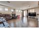 Spacious living room with hardwood floors, recessed lighting, and oversized leather sofa at 9746 Vista Cache Ct, Las Vegas, NV 89148